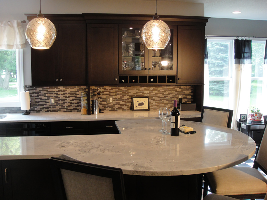 kitchen counter with chairs, wine bottle, glasses
